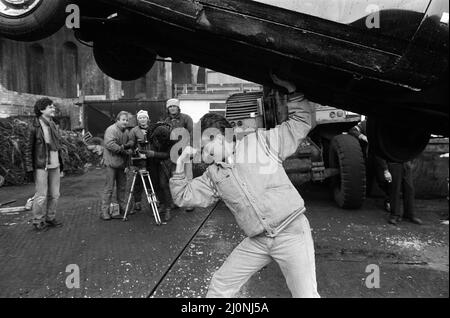 UB40 filming a video film in a scrapyard. The video film will feature songs from their album 'Labour of Love'. Pictured, Brian Travers, saxophonist with the band and producer of the video. 21st January 1983. Stock Photo