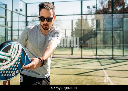 Man playing paddle tennis. Outdoor sport Stock Photo