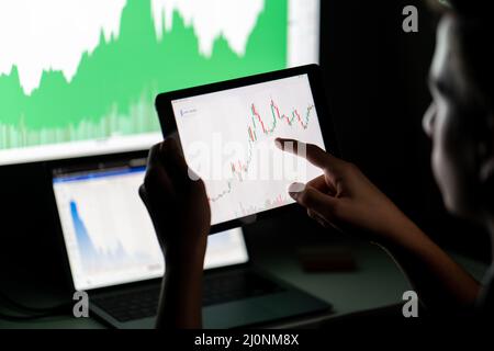 Crypto trader investor analyst looking at computer screen analyzing financial graph data on pc Stock Photo