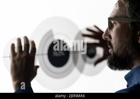 Close up of hand using creative business chart hologram settings on tech background Stock Photo