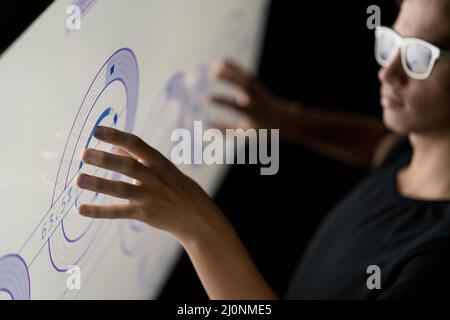 Close up of hand using creative business chart hologram settings on tech background Stock Photo