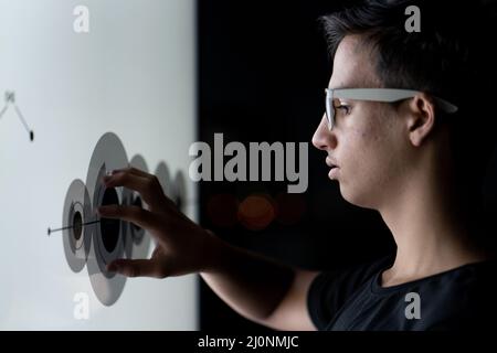 Close up of hand using creative business chart hologram settings on tech background Stock Photo