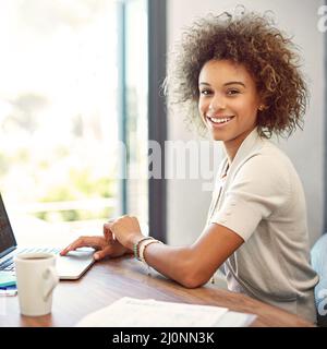 Becoming self employed is the best decision Ive made. Portrait of a young woman working on a laptop at home. Stock Photo