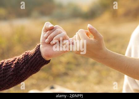 Man woman making pinky promise (1) . High quality and resolution beautiful photo concept Stock Photo