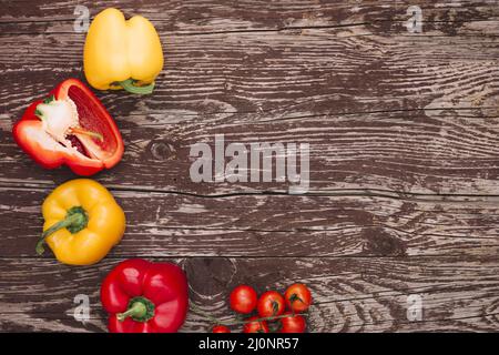 Red yellow bell peppers cherry tomatoes wooden desk . High quality and resolution beautiful photo concept Stock Photo