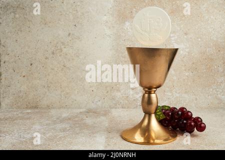 Christian holy communion with Chalice on stone background Stock Photo