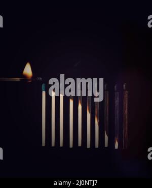 Match stick burning. Match stick in black background. Different stages of match sticks burning. Match stick.  Burnt matchsticks in black background . Stock Photo