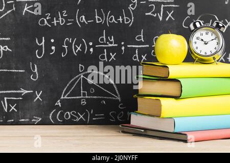 School desk with textbooks near blackboard . High quality and resolution beautiful photo concept Stock Photo