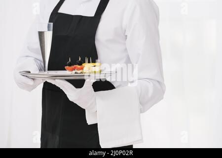 Servant uniform holding tray. High quality and resolution beautiful photo concept Stock Photo