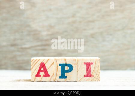Alphabet letter block in word API (Abbreviation of Application programming interface or Active pharmaceutical ingredient) on wood background Stock Photo