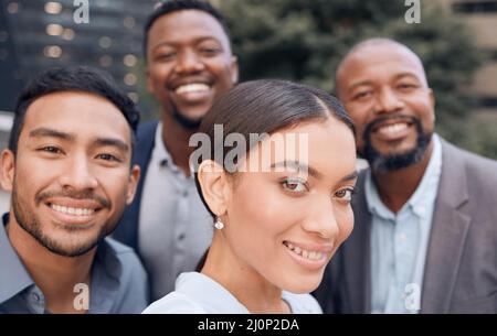 Making memories together. Shot of a group of businesspeople standing outside together. Stock Photo