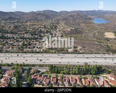 Aerial view of highway with traffic surrounded by houses, Interstate 15 with in vehicle movement. Stock Photo