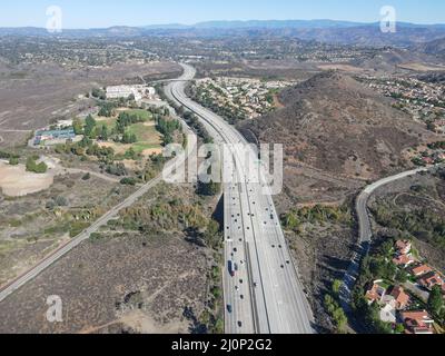 Aerial view of highway with traffic surrounded by houses, Interstate 15 with in vehicle movement. Stock Photo