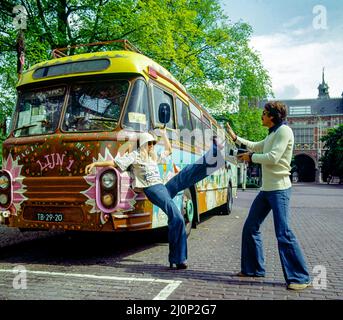 Vintage Amsterdam 1970s, couple taking funny pictures, hippy styled decorated van, Holland, Netherlands, Europe, Stock Photo