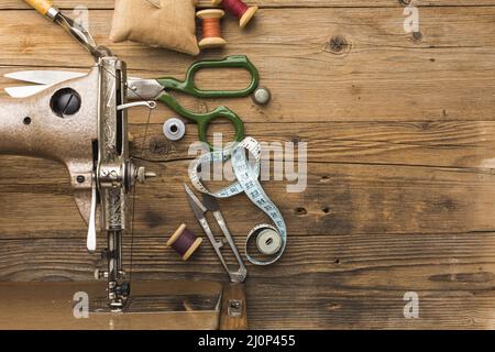 Top view of vintage sewing machine with scissors and thread. High quality and resolution beautiful photo concept Stock Photo