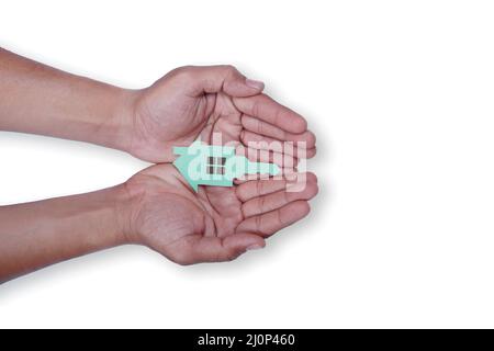 hands holding paper house with key, family home, homeless shelter and real estate, housing and mortgage crisis, foster home care, family day care, soc Stock Photo