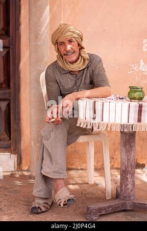 Bedouin men relaxing and smoking in a caffe in a town of mhamid in morocco Stock Photo