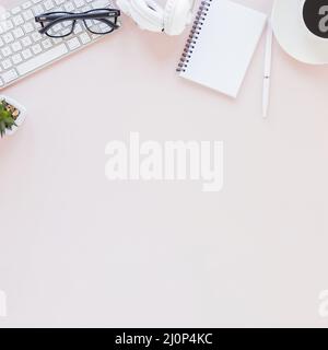 Workplace with various gadgets notebook coffee cup pink background. High quality and resolution beautiful photo concept Stock Photo
