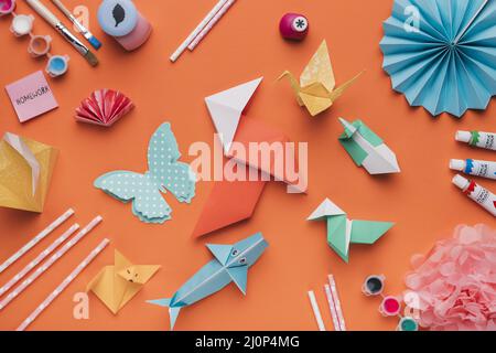 Set origami paper art paintbrush watercolor straw orange backdrop. High quality and resolution beautiful photo concept Stock Photo