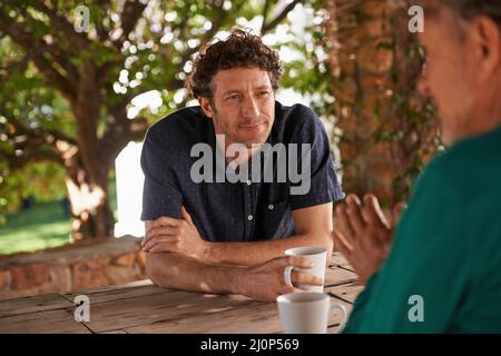 Fathers in law have a lot of advice. Shot of a handsome man listening to what his father has to say. Stock Photo