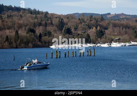 Loch Lomond near Balloch, Scotland wth the marina in the background, seagulls and cormorants on posts and motor boat in the foreground. Stock Photo
