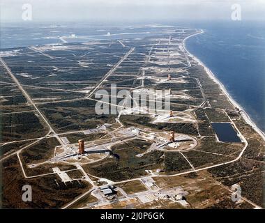 Overall aerial view of Missile Row, Cape Canaveral Air Force Station. The view is looking north, with the Vehicle Assembly Building (VAB) under construction, in the upper left hand corner.