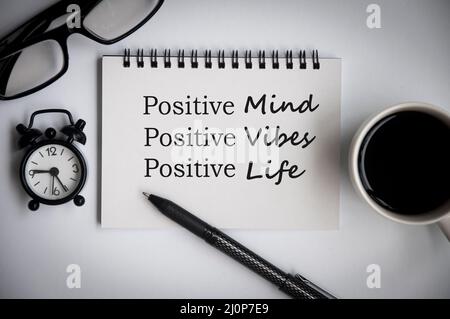 Motivational and inspirational quote text on notepad - Positive mind, vibes and life. With office concept background Stock Photo