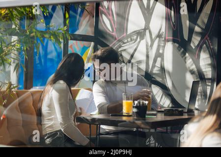 Co-workers spending time together on a break while working on a project on a lovely sunny day. Stock Photo