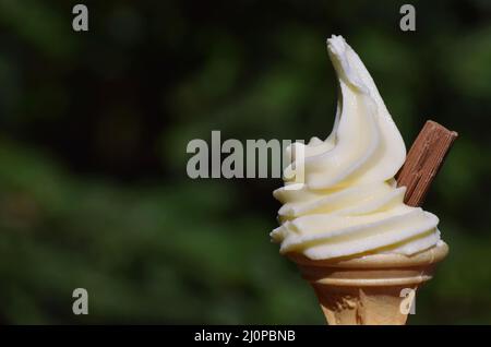 Soft whipped vanilla ice cream with a chocolate flake in a wafer cone. Known as a flake 99 or Mr Whippy in the UK Stock Photo