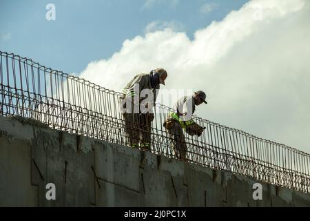 Goiânia, Goias, Brazil – March 19, 2022: Workers of the city hall, in uniform, carrying out a public work. City officials working on an overpass. Stock Photo
