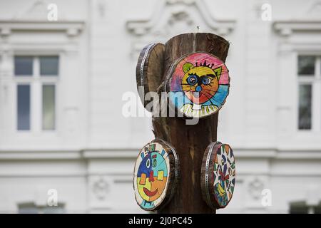 Work of art scrubbing stake tree discs, designed by children, art project Halver, Germany, Europe Stock Photo