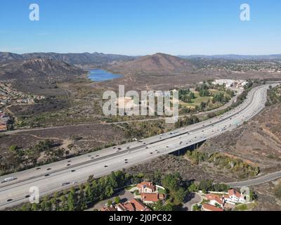 Aerial view of highway with traffic surrounded by houses, Interstate 15 with in vehicle movement. Stock Photo