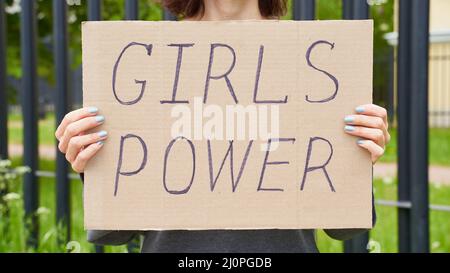 Girl Power concept. Unrecognizable person holds sign with text about feminism Stock Photo