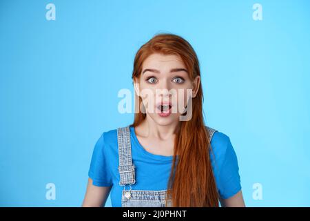 Shocked redhead girl react omg shook, drop jaw speechless, stare ...