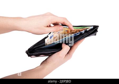 A man is holding an open wallet with money on a white background close-up Stock Photo