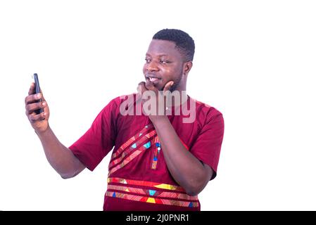 handsome happy young man having video call on cellphone smiling. Stock Photo