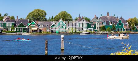 Zaanstad, The Netherlands - July 18, 2021: Panorama with traditional dutch gable house along water in in Zaanse Schans Village in Zaanstad North Holland The Netherlands Stock Photo