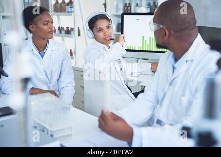 Combined skills for comprehensive scientific studies. Shot of a group of scientists conducting research in a laboratory. Stock Photo