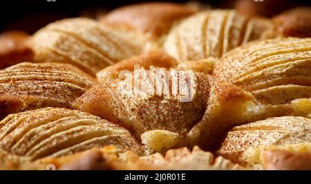 A fully baked apple pie with cinnamon sprinkled over the apples. Stock Photo