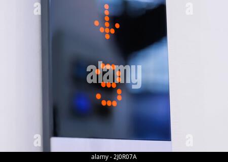 Digital elevator display showing floor number - 3 - lift going down: close up Stock Photo