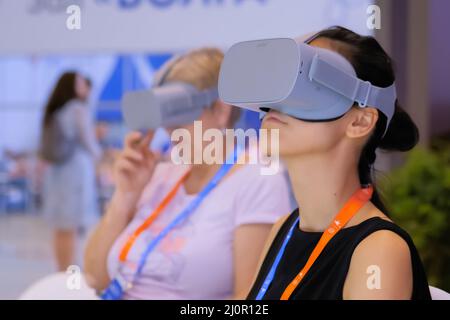 Woman using virtual reality headset at VR technology exhibition Stock Photo