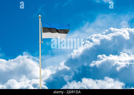 Estonian national flag waving on blue sky background. Republic of ...