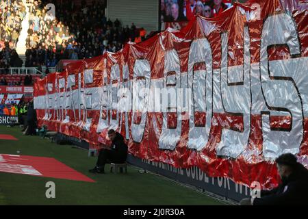 MIDDLESBROUGH, UK. MAR 19TH Middlesbrough's fans hold up a banner in front of the south stand as the Chelsea fans are illuminated by the evening sunshine during the FA Cup match between Middlesbrough and Chelsea at the Riverside Stadium, Middlesbrough on Saturday 19th March 2022. (Credit: Mark Fletcher | MI News) Credit: MI News & Sport /Alamy Live News Stock Photo