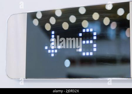 Digital elevator display showing floor number - 3: lift going down: close up Stock Photo