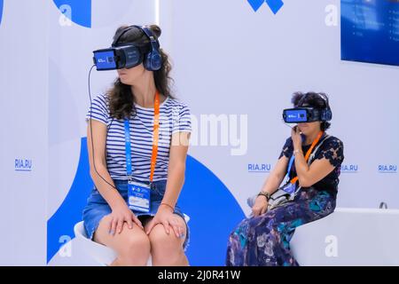 Two women using virtual reality headset at VR technology exhibition Stock Photo