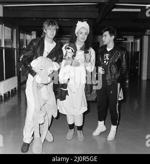 Pop group Culture Club arrive at Heathrow Airport from Madrid. Pictured, left to right, John Suede, Boy George and  Jon Moss. 5th November 1983. Stock Photo