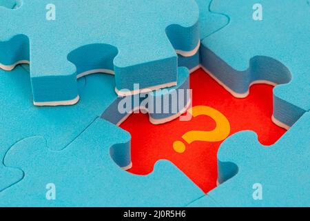 Missing piece of the puzzle with question mark Stock Photo