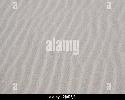 Rippled, wavy white sand background texture pattern Stock Photo