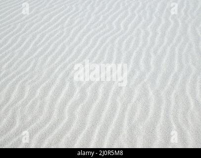 Rippled, wavy white sand background texture pattern Stock Photo