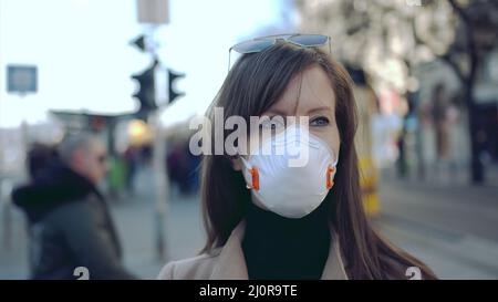 Coronavirus disease - woman wearing face mask in public to protect herself from the covid-19 virus. Stock Photo